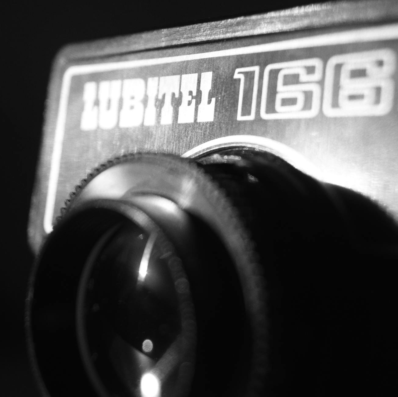Black and white close-up of a vintage Lubitel 166 camera lens.