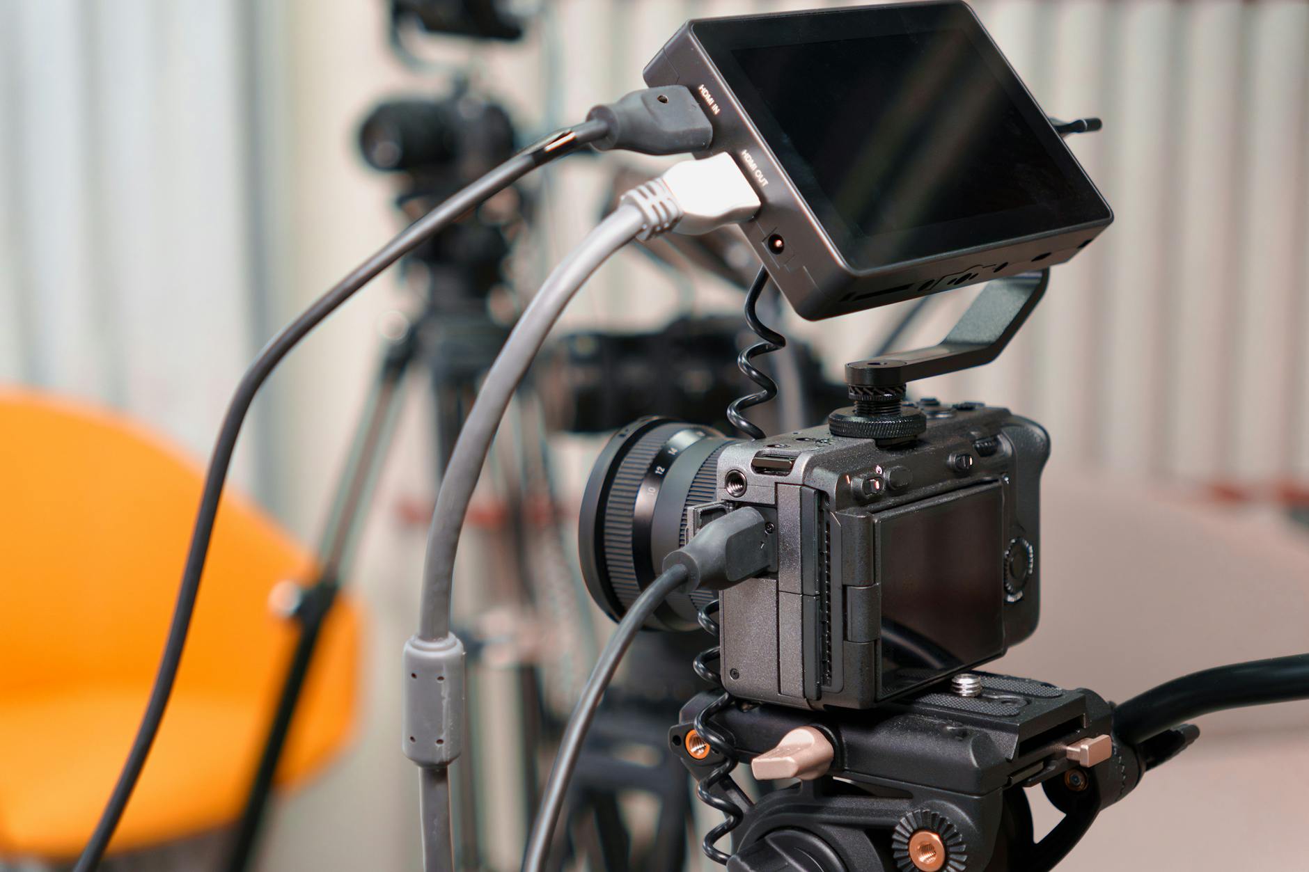 Close-up of a professional video camera setup in a modern studio environment.