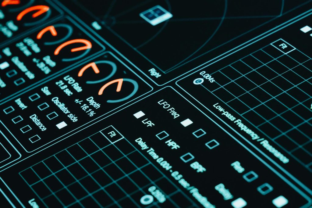 Close-up of a digital interface showcasing futuristic graphs and data analytics in low light.