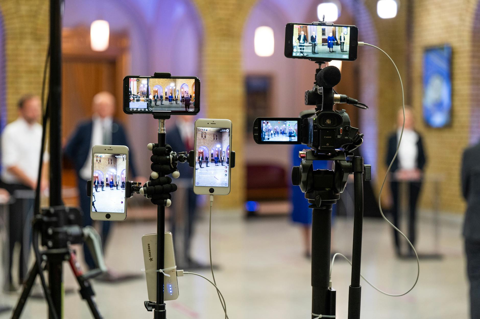 Multi-camera setup capturing a live event indoors, showcasing modern filming technology.
