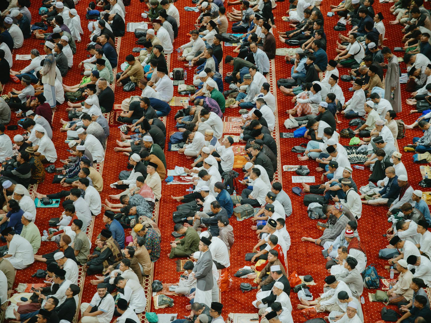 A large gathering of Muslims participating in Eid prayer at Istiqlal Mosque, Jakarta from above.