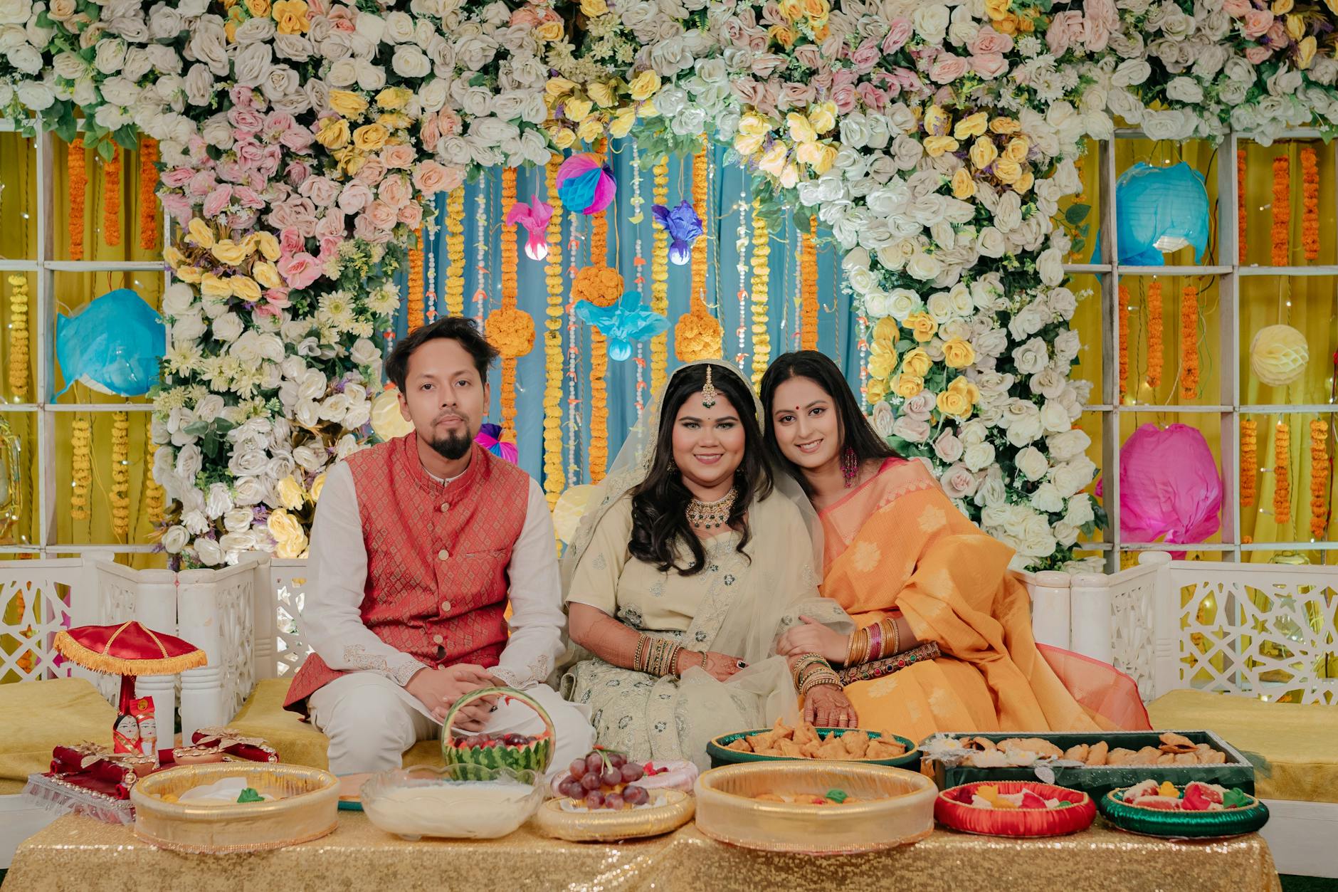 Joyful Indian wedding gathering with friends, vibrant decor, and traditional attire.