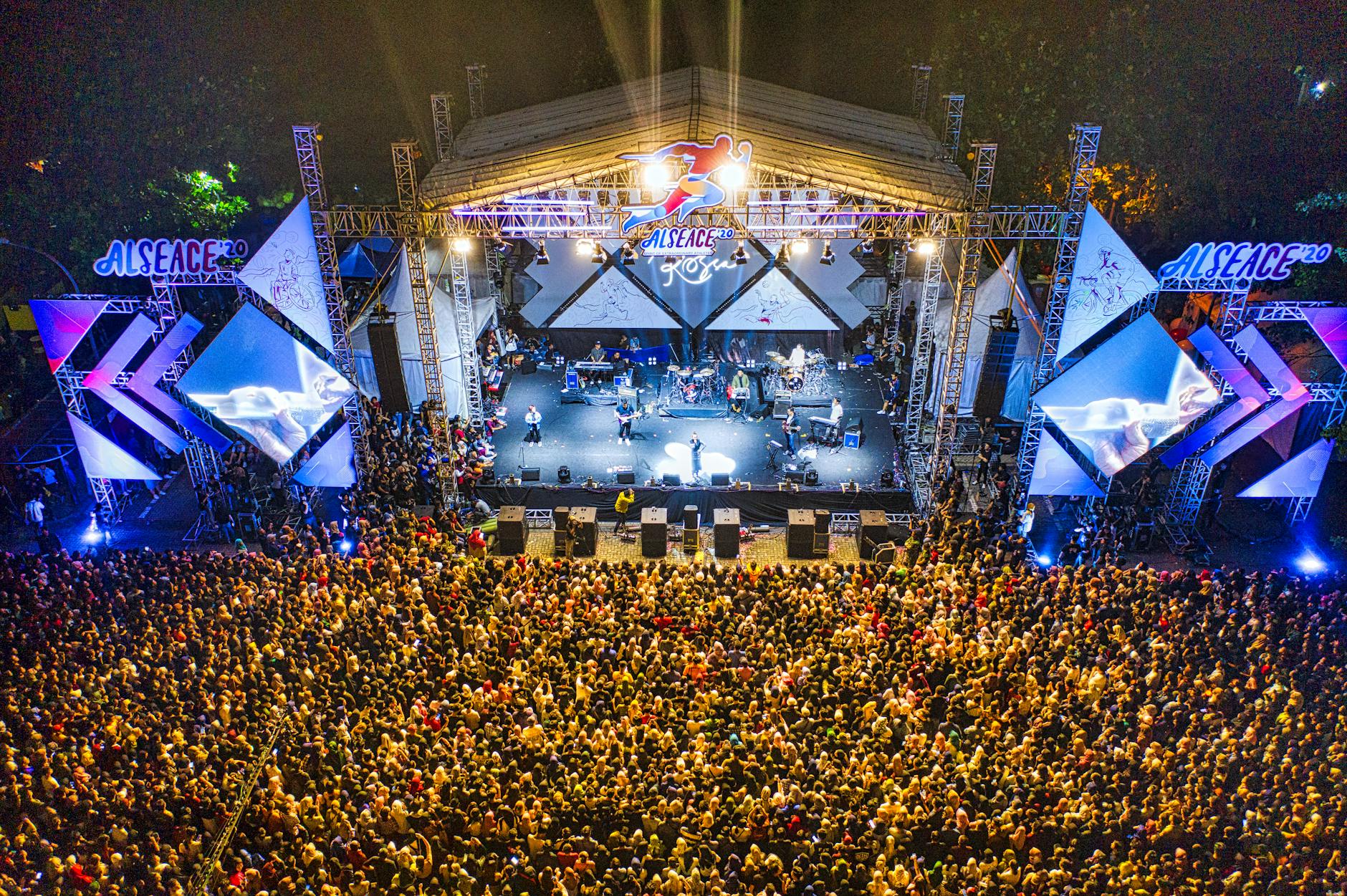 Vibrant night concert captured from above in Banten, Indonesia, showcasing a lively crowd and illuminated stage.