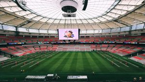 Interior view of BC Place Stadium in Vancouver, showcasing its vast seating and advanced roof structure.