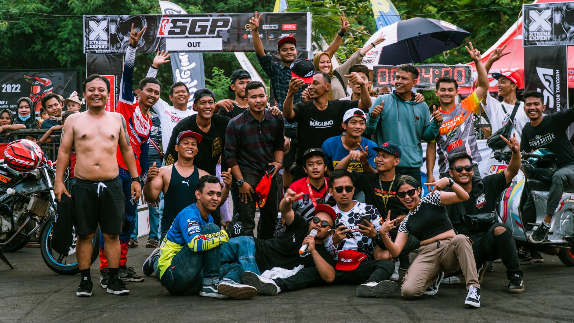Group of riders pose for a photo at a motorcycle stunt competition in Jakarta, Indonesia.