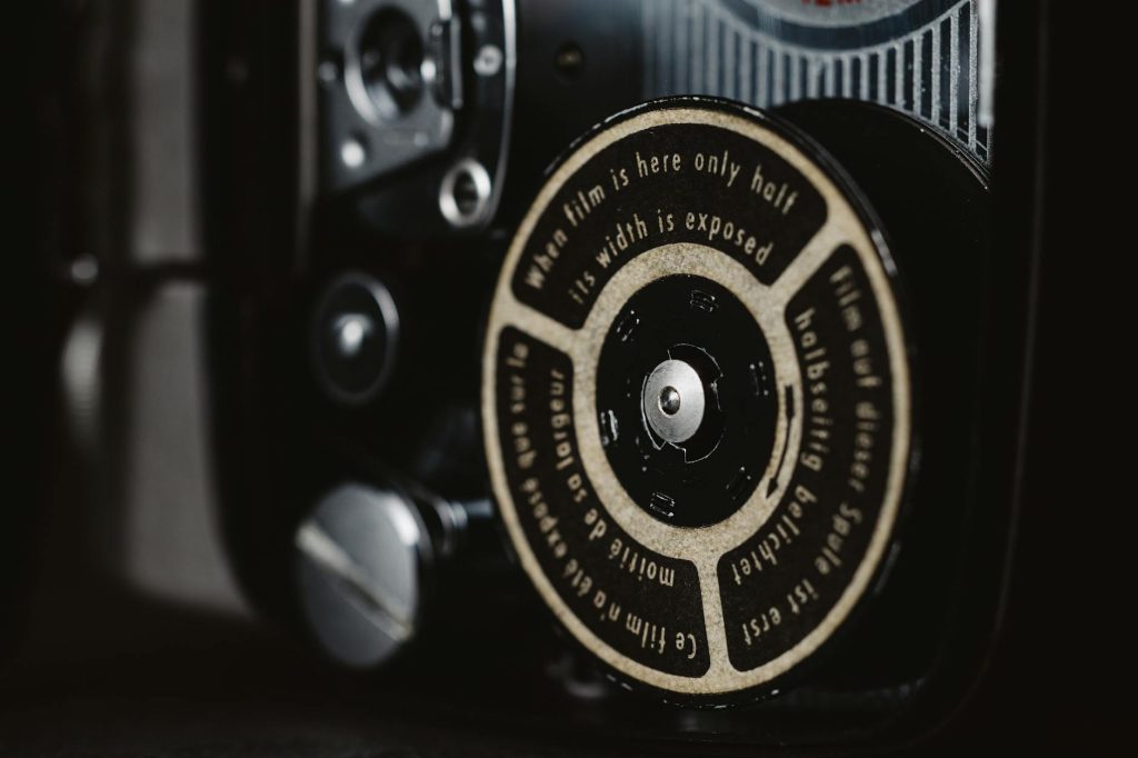 Detailed view of a classic camera film mechanism with text on the dial.