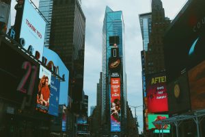 Bustling Times Square with bright billboards and towering skyscrapers in New York City.