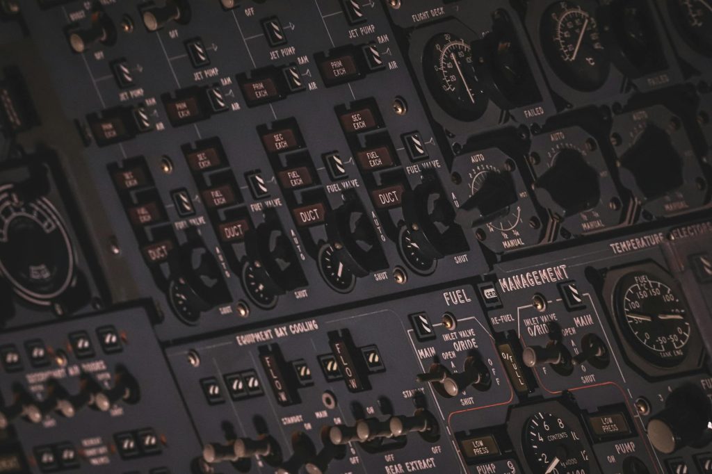 Detail view of an aircraft's sophisticated control panel with instruments and switches.