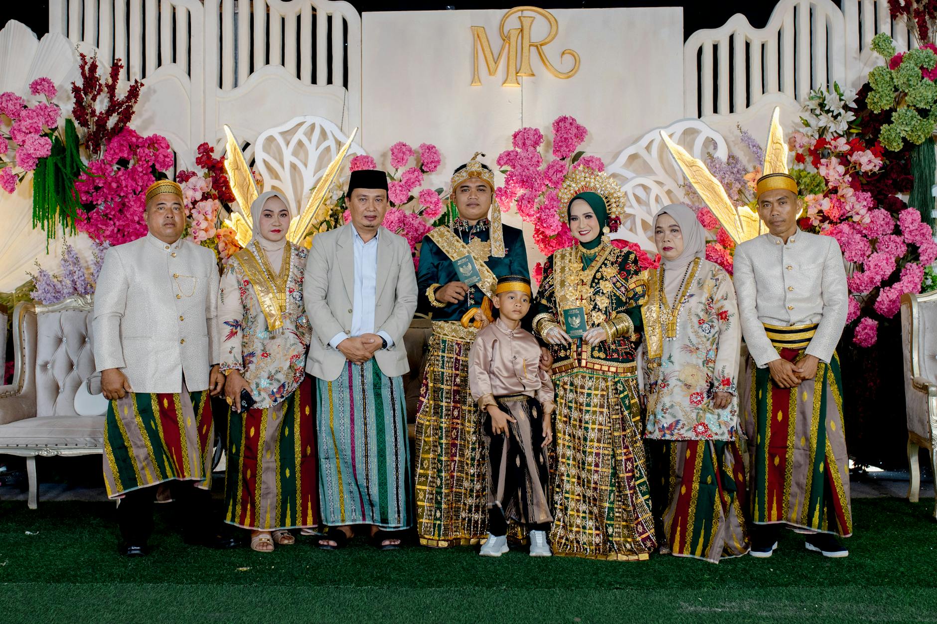 A vibrant traditional wedding ceremony with participants in ornate attire in Kendari, Indonesia.