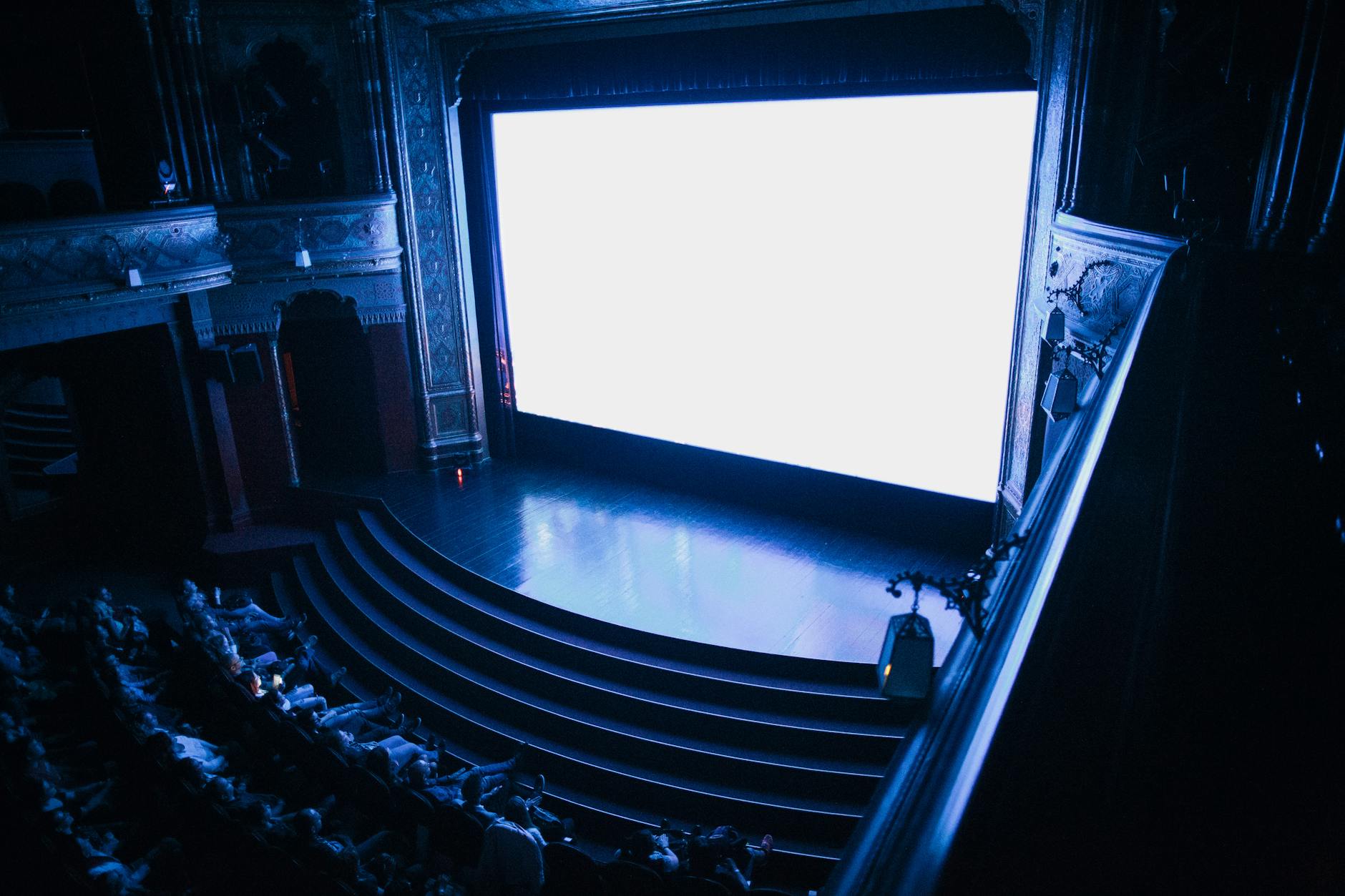Explore the grandeur of Budapest's historic cinema, showcasing its rich architectural details and audience seating.