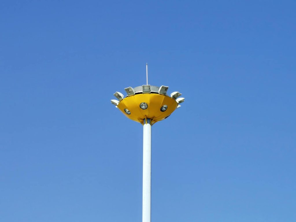 A yellow street lamp against a clear blue sky, offering a minimalistic and modern look.