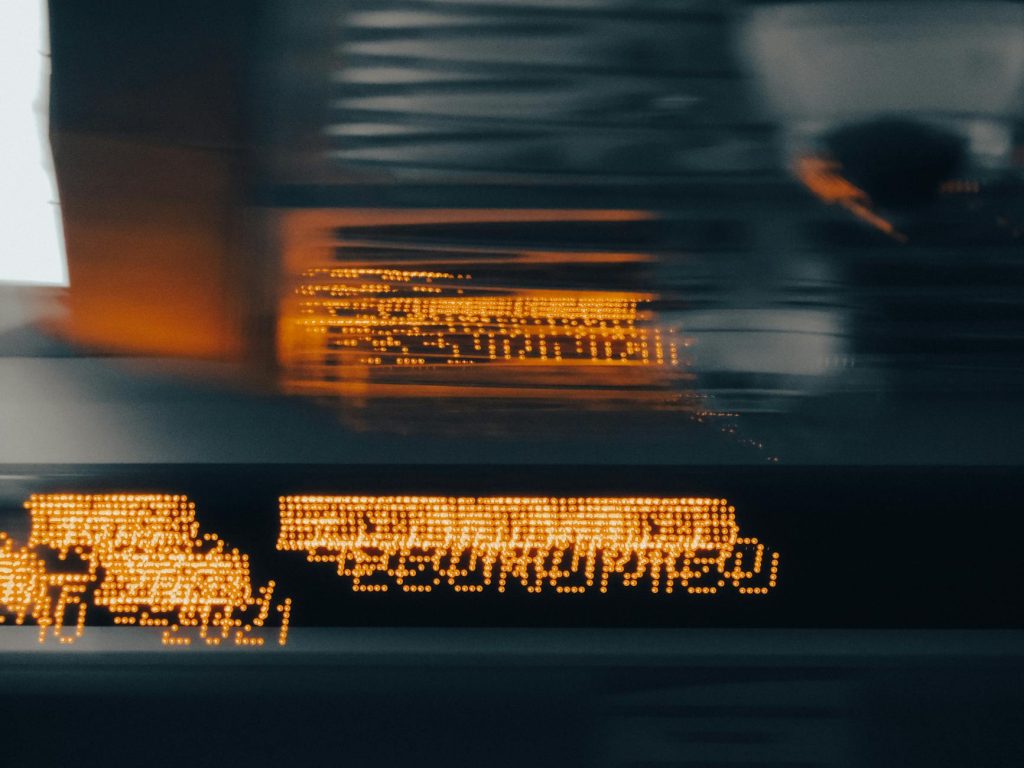 Blurred LED lights display abstract text in motion, creating an artistic effect.