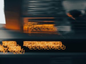 Blurred LED lights display abstract text in motion, creating an artistic effect.