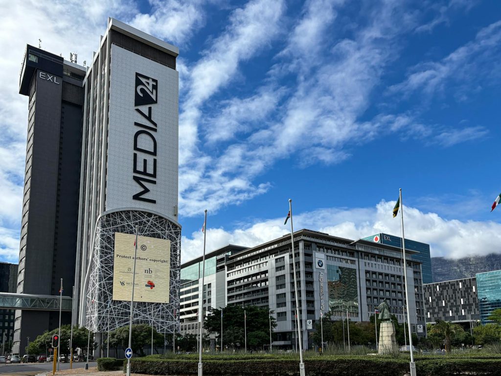 Urban cityscape featuring the prominent Media24 building in Cape Town with clear skies.