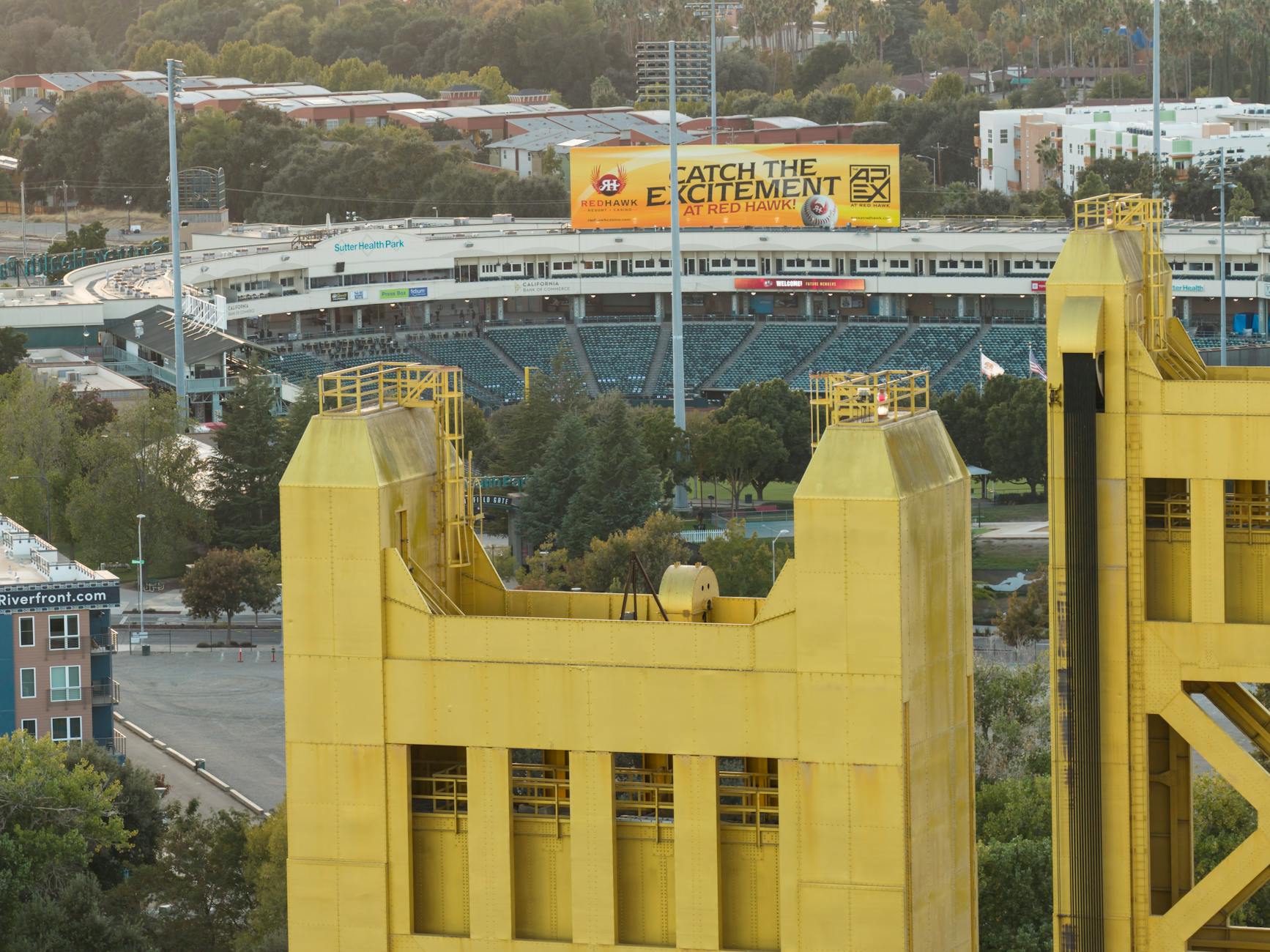 View of the iconic Sacramento Tower Bridge with a baseball stadium in the background, showcasing urban architecture.