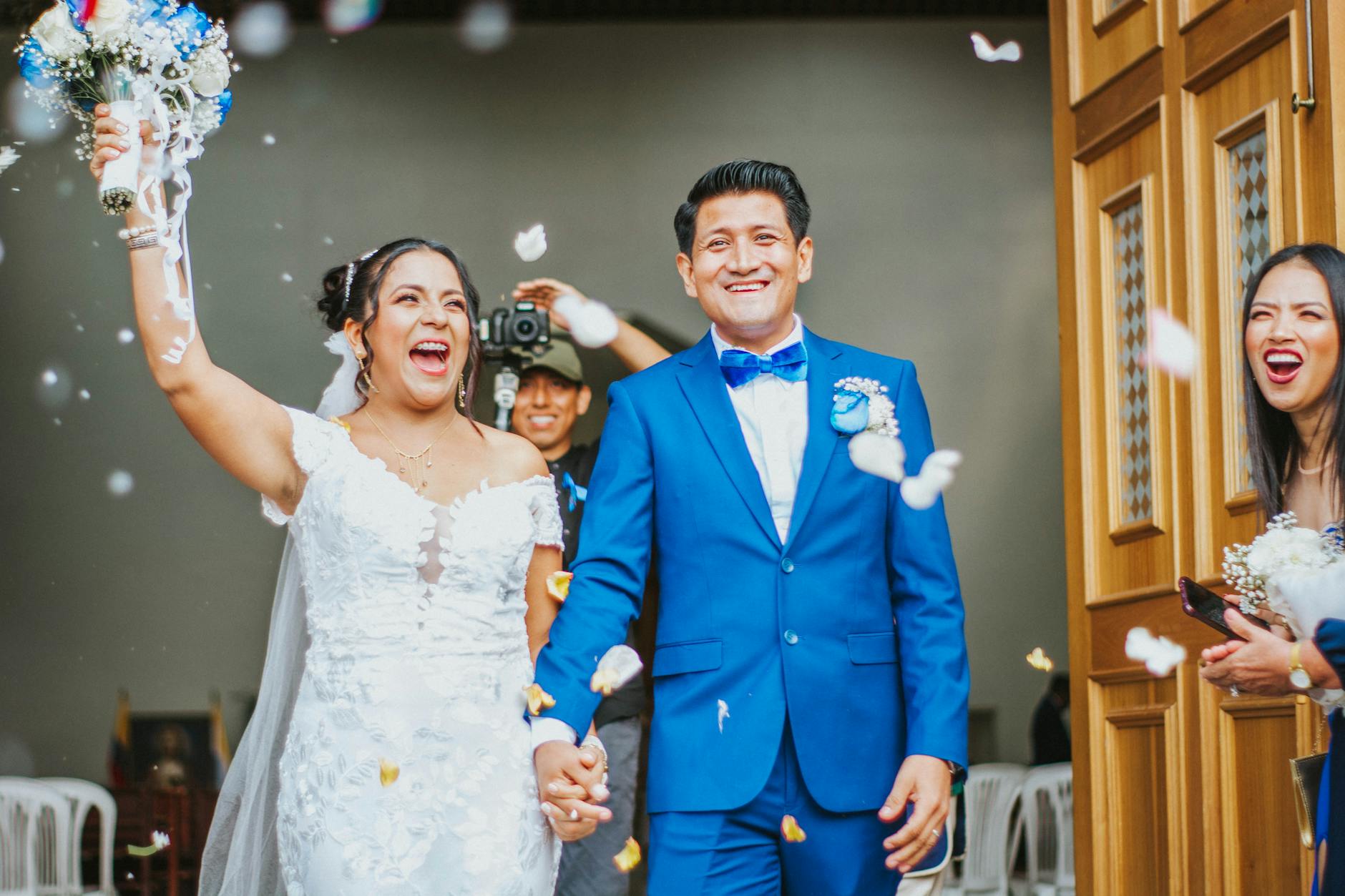 A newly married couple celebrates outside the church in Guayaquil, Ecuador, surrounded by friends and confetti.