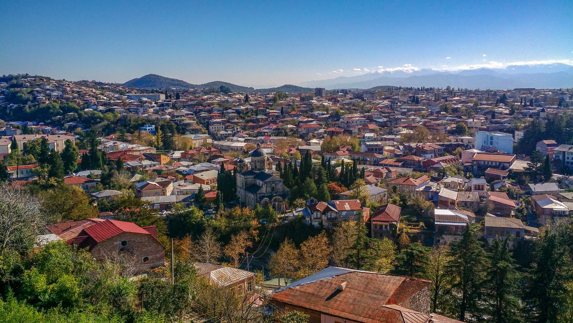 Explore the stunning aerial view of Kutaisi, Georgia, showcasing vibrant architecture and lush greenery.