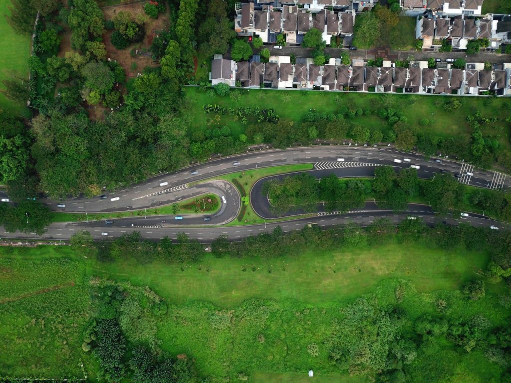 Aerial view of winding roads surrounded by greenery and houses in Serpong, Banten.