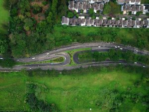 Aerial view of winding roads surrounded by greenery and houses in Serpong, Banten.