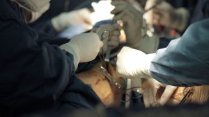 Team of surgeons executing a delicate surgical procedure in an operating room.