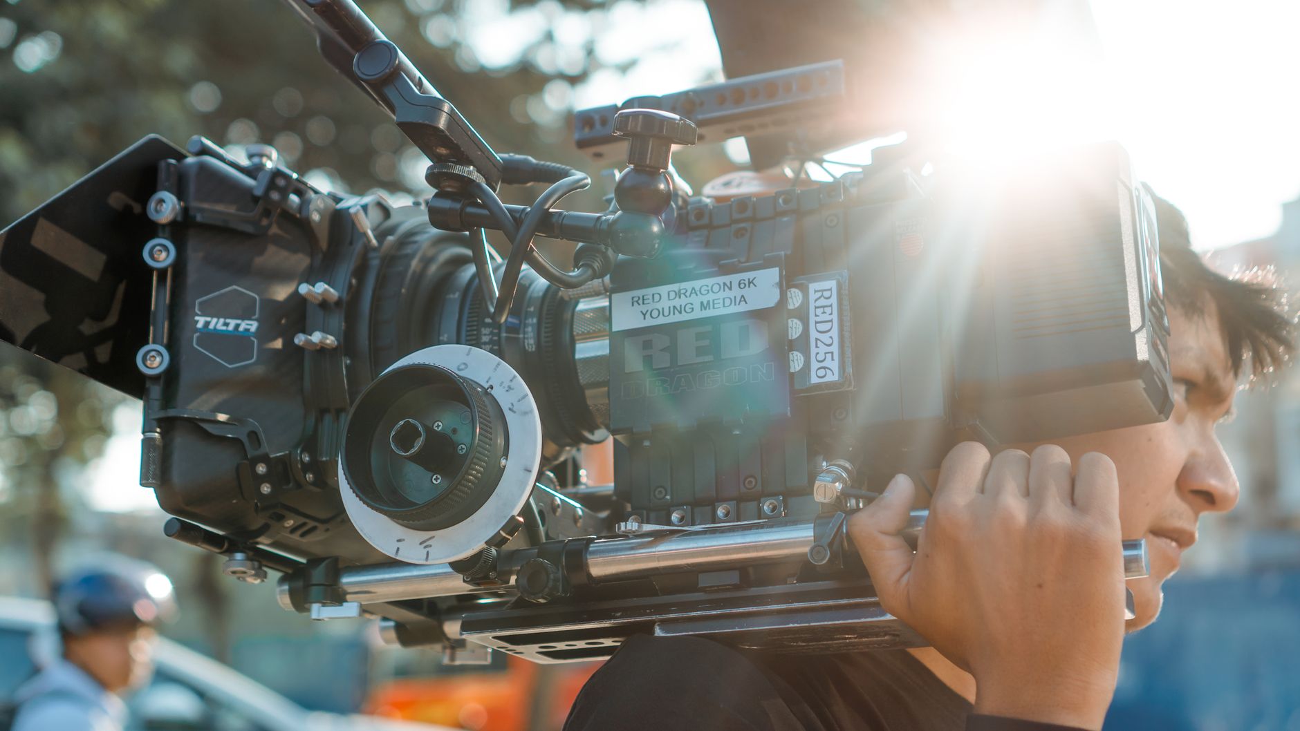 Close-up of a cinematic camera in use during an outdoor film shoot, capturing the professional filmmaking process.